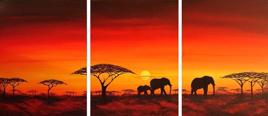 Elephants walking in the dusk