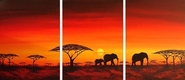 Elephants walking in the dusk