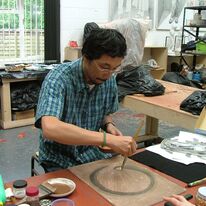 Image 1 - Artist Masashi demonstrating Japanese painting techniques during our open studio exhibition for the Artists and Makers Festival