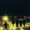 photograph of figures on acetate, stuck to a window and re-photographed on my window with view of city landscape at night