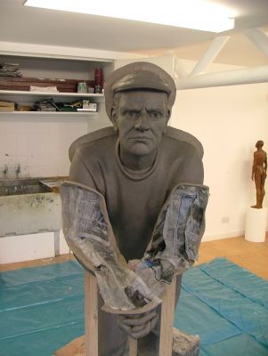 Clay walls added to divide sculpture into sections for casting with damp paper to protect surface.