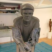 Clay walls added to divide sculpture into sections for casting with damp paper to protect surface.