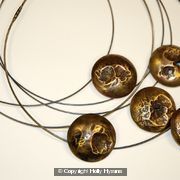 collection of earth from air brass domed pendants on oxidised silver cables
