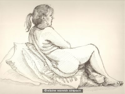 Sarah seated with cushions